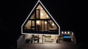 a large building with a large window in a room at Pine Chalet - sauna & jacuzzi in Smižany