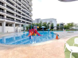a swimming pool with a playground in a building at Encorp Marina Puteri Harbour Bathtub Netflix in Iskandar Puteri
