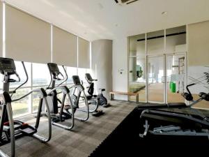 a gym with a bunch of exercise bikes in a room at Encorp Marina Puteri Harbour Bathtub Netflix in Iskandar Puteri