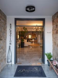 a entrance to a store with a sign on the door at Parosland Hotel in Aliki