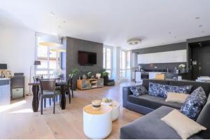 a living room with a couch and a dining room at La petite Venise des Alpes, Ultra centre 1 à 5 Pers in Annecy