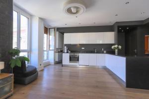 a large kitchen with white cabinets and white appliances at La petite Venise des Alpes, Ultra centre 1 à 5 Pers in Annecy