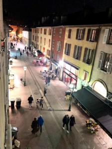 a group of people walking down a street at night at La petite Venise des Alpes, Ultra centre 1 à 5 Pers in Annecy