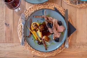 a plate of food with meat on a table at Parosland Hotel in Aliki