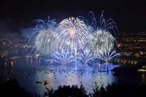 a firework display over the water with a city at La petite Venise des Alpes, Ultra centre 1 à 5 Pers in Annecy
