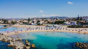 a group of people on a beach in the water at dalie's house San Leone Centro in Agrigento