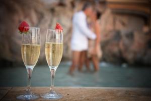 two glasses of champagne with a strawberry in them at Hotel Villa Margherita in Quercianella