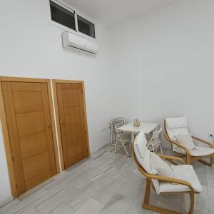 a room with chairs and a table and a window at El Rincón de Don Gonzalo in Puente Genil +2 photos