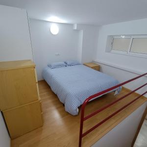 a small bedroom with a bed and a dresser at El Rincón de Don Gonzalo in Puente Genil