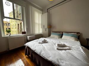 a bedroom with a large bed with towels on it at Historical Flat in Galata - Tatar Beyi Street in Istanbul +16 photos