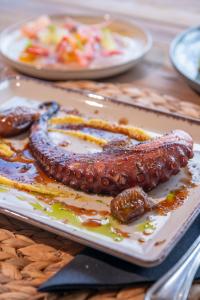 a plate of food with sausages on a table at Parosland Hotel in Aliki