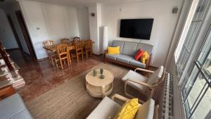 a living room with a couch and a table at Casa Frijol 20metres from the beach in Los Alcázares