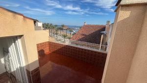 a view of a balcony of a building with a fence at Casa Frijol 20metres from the beach in Los Alcázares