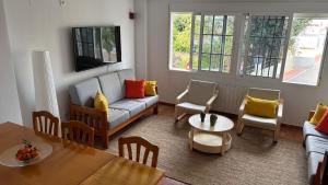 a living room with a couch and a table at Casa Frijol 20metres from the beach in Los Alcázares