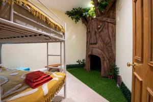 a bedroom with a tree next to a bunk bed at Witches Mill Castletown in Castletown