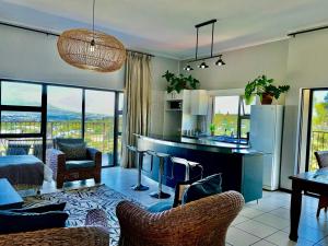 a living room with a kitchen and a living room with a view at Welgemoed Villa in Bellville