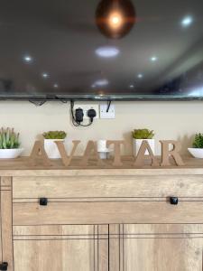 a wooden sign that says warmite on a counter at افتار شالية avatar chalet in Al Raka