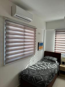 a bedroom with a bed and a window with blinds at Sunset View Penthouse Apartment 2 Bedrooms Tatlisu in Akanthou +40 photos
