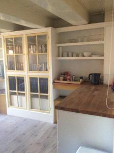 a kitchen with white cabinets and a counter top at Truelove Guesthouse in Amsterdam