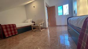 a bedroom with a bed and a desk and a chair at Casa Frijol 20metres from the beach in Los Alcázares
