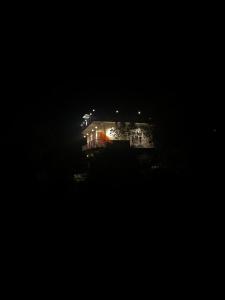 a house at night with lights in the dark at Akaasa homes in Baijnāth
