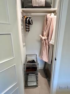 a walk in closet with towels and a door at Hotel at Home in Shoreham by Sea in Shoreham-by-Sea