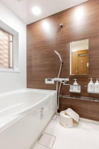 a bathroom with a bath tub and a mirror at kensui house in Tokyo +20 photos