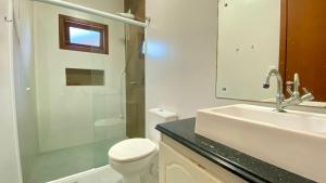 a bathroom with a sink and a toilet and a shower at Casa praia bombinhas 130m mar in Bombinhas +41 photos
