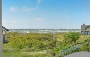 a view of the ocean from a house at Three-Bedroom Holiday Home In Blokhus in Blokhus +23 photos