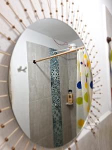 a mirror in a bathroom with a shower at Hostal Prana in Abejorral