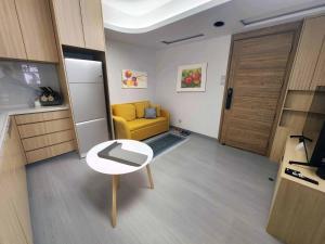 a living room with a yellow couch and a door at Pillows CoLiving in Hong Kong