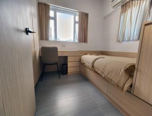 a bedroom with a bed and a chair and a window at Pillows CoLiving in Hong Kong