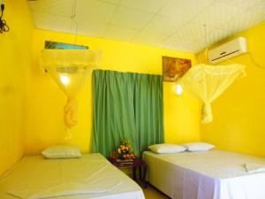 Posteľ alebo postele v izbe v ubytovaní The Nilmini Lodge