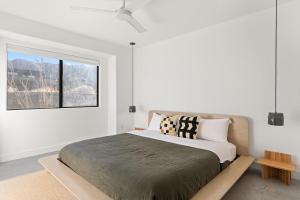 a bedroom with a large bed with a window at Zendo House By The Cohost Company in Joshua Tree +25 photos
