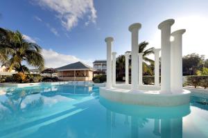 a swimming pool with columns and a building at Grand Palladium Lady Hamilton Resort & Spa - All Inclusive in Lucea