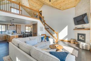 a living room with a couch and a table at Meadowlark Mountain Club with Views of the Rockies in Bordenville