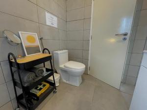 a bathroom with a white toilet and a shower at Casa da praia in Aljezur +18 photos