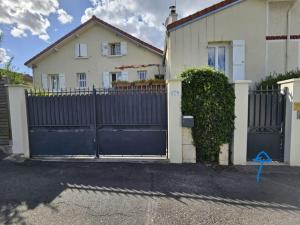リュエイユ・マルメゾンにあるlogement entier indépendant dans maisonの家の前の青い柵