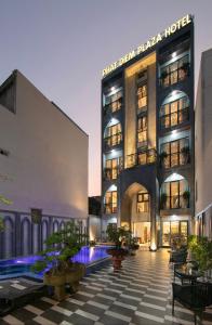 a hotel with a pool in front of a building at Phat Diem Plaza Hotel in Ninh Binh