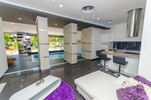 a kitchen and living room with a purple rug at La Vela Luxury in Trogir