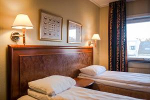 Postel nebo postele na pokoji v ubytování Quality Hotel Grand Steinkjer + 25 fotografií