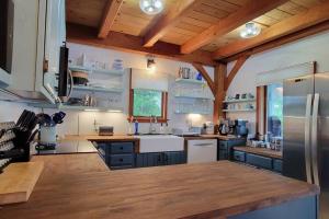 a kitchen with blue cabinets and a refrigerator at Waneta Way Cottage in Hammondsport