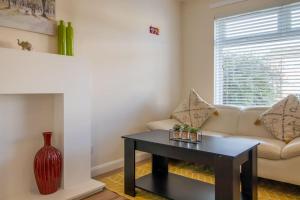 a living room with a couch and a table at Lena House in Glasgow