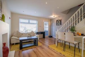a living room with a couch and a table at Lena House in Glasgow