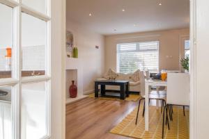a kitchen and living room with a table and a couch at Lena House in Glasgow