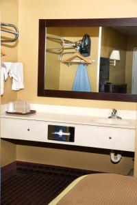 a bathroom with a sink and a mirror at Executive Inn Opp in Opp