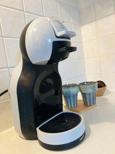 a black and white coffee maker sitting on a counter at La Toulousaine 