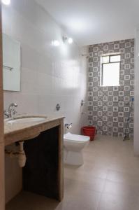 a bathroom with a sink and a toilet at 1 BHK Private Apartment in Varca