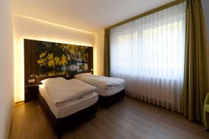 Ένα ή περισσότερα κρεβάτια σε δωμάτιο στο Waldhotel