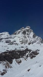 a mountain covered in snow with a blue sky at Cielo Alto I Dadi in Breuil-Cervinia